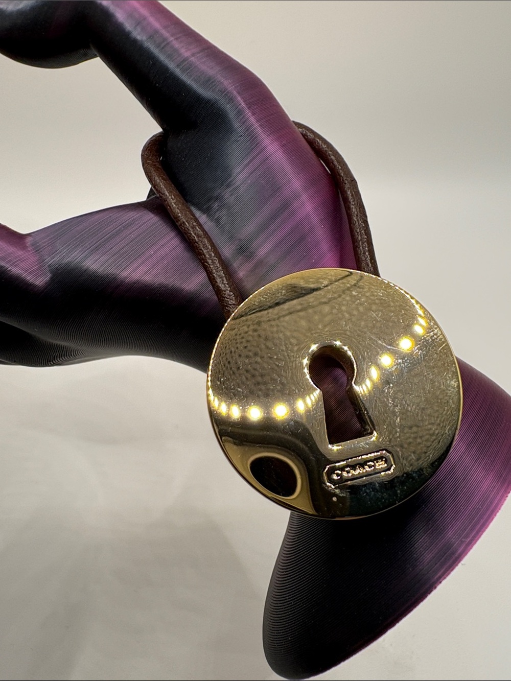 Coach Gold-Tone Padlock Charm on Brown Leather Loop